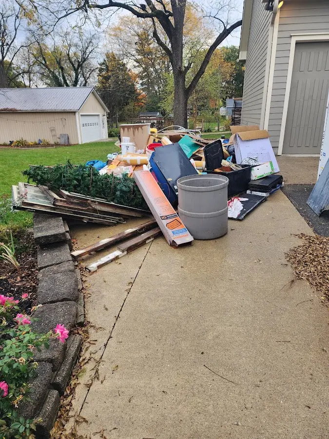Dumpster being loaded with debris for Estate Cleanout Dumpster Rental in Seabrook